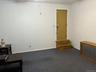 Carpeted spare room featuring baseboards