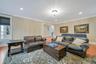 Living room featuring wood-type flooring and crown molding