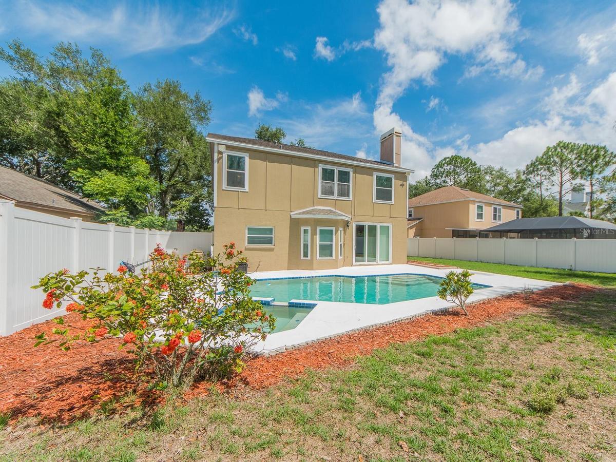 Backyard showing pool & house