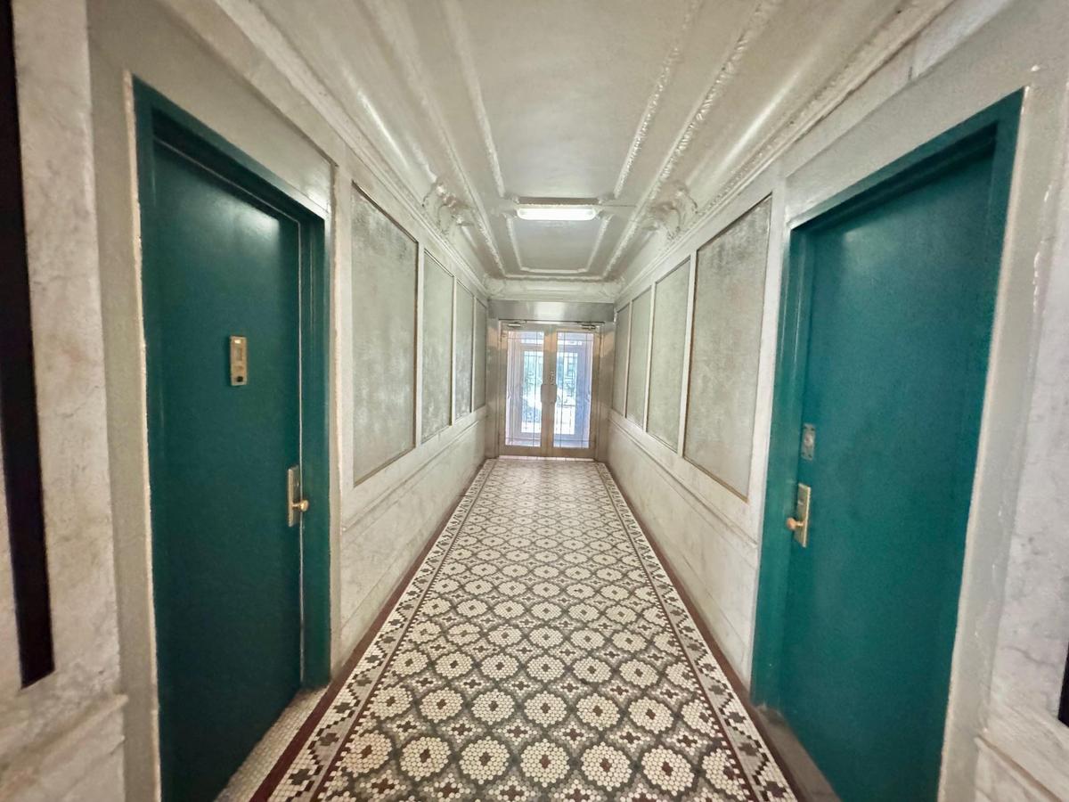 Hall with ornamental molding and a decorative wall