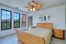 A wall of windows in the primary bedroom with gorgeous view