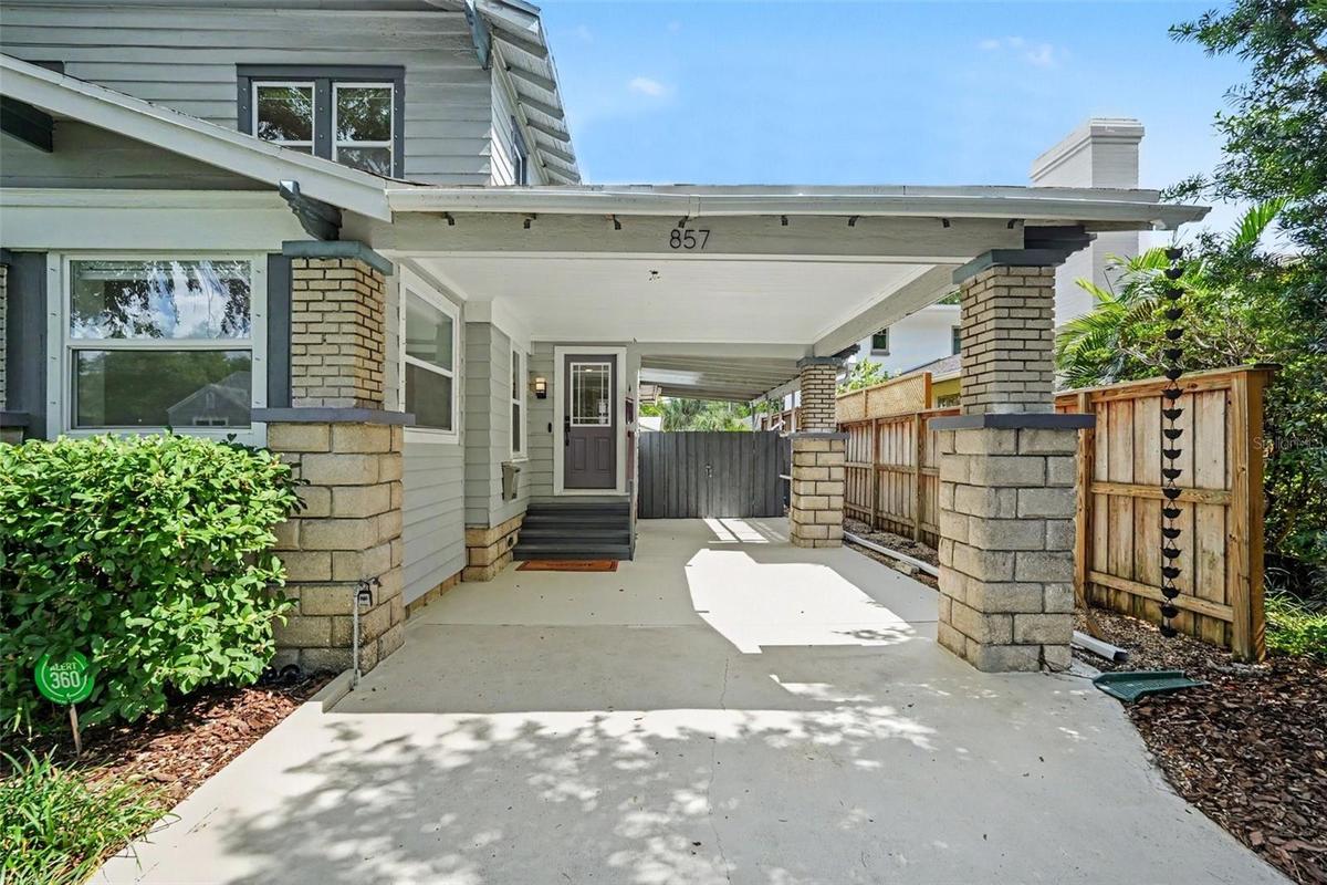 The tandem carport offers exceptional everyday convenience while preserving the home’s distinctive historic character.