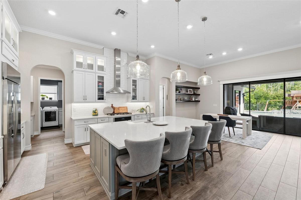 Oversized kitchen island provides space for entertaining guests and dining.