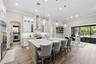 Oversized kitchen island provides space for entertaining guests and dining.