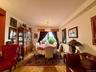 Open to the living room, double panel window, hardwood floors
