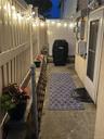 Patio at night with a fenced backyard and a patio