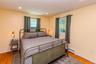 Hardwood flooring, recessed lighting, and two windows with natural light