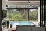The impact-glass doors slide open to combine the indoor and outdoor living spaces.