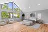 Bedroom featuring baseboards, light wood-type flooring, high vaulted ceiling, and recessed lighting (virtually staged)