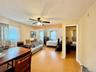 4 - Bedroom with multiple windows, light wood-type flooring, ceiling fan, and baseboards