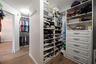 Owner's suite walk-in closet features every type of built-in storage you need