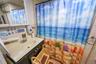 Bathroom featuring curtained shower, tile walls, vanity, and tile patterned flooring