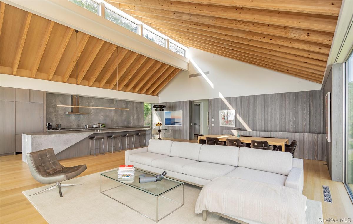 Living room with wood finished floors and high vaulted ceiling