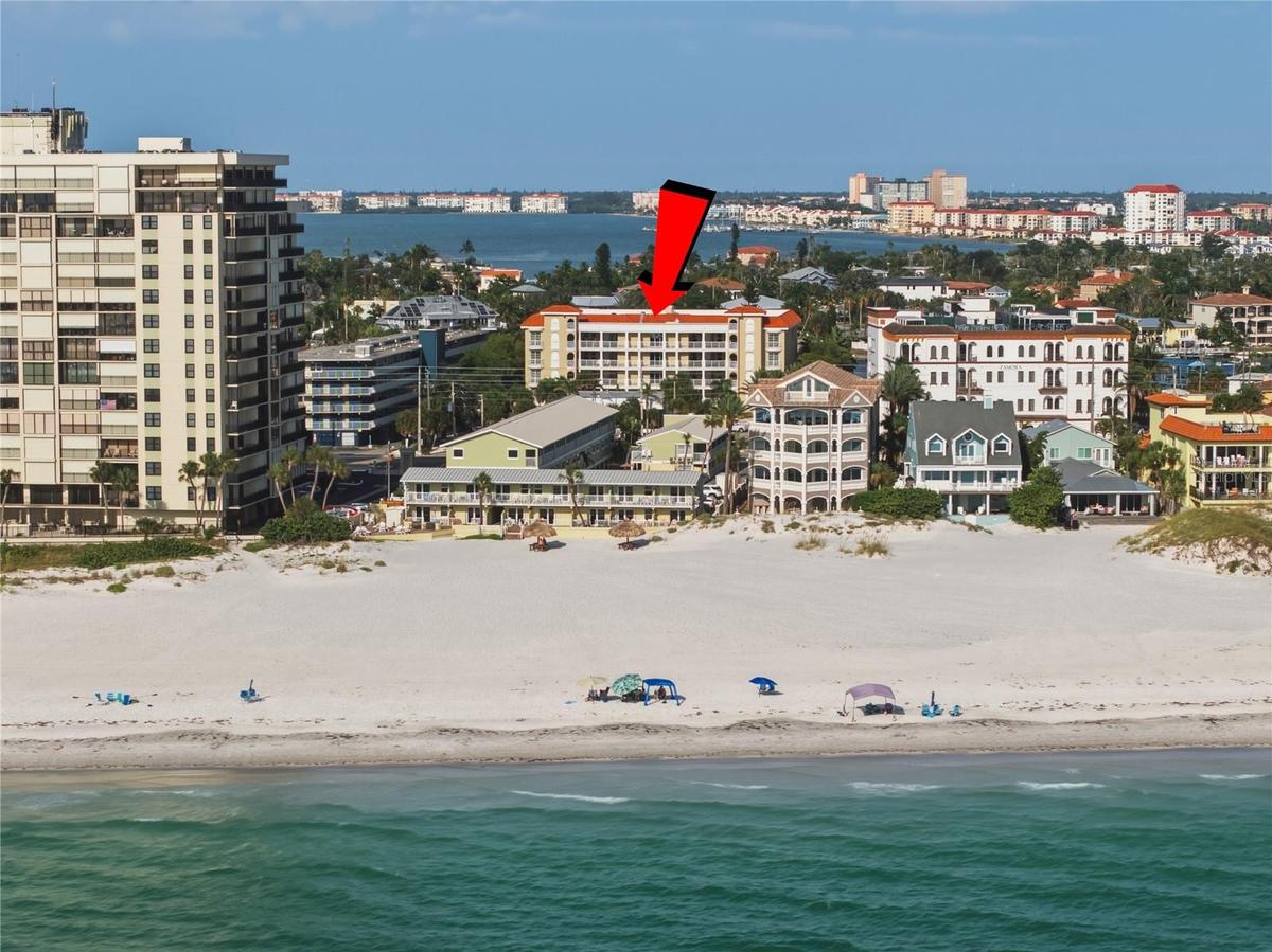 This photo highlights the building's prime location and its immediate proximity to the beach.
