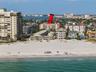 This photo highlights the building's prime location and its immediate proximity to the beach.