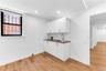 Wet bar with cabinetry on lower level