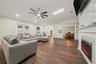 Spacious Family Room featuring Electric Fireplace & Stone tile accent wall