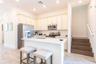 Modern kitchen with large island and open layout in Kissimmee Florida resort style home