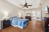 Spacious primary suite with tray ceiling and large walk-in closet