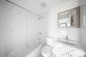Bathroom featuring vanity, tub / shower combination, and tile walls