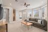 Second-floor loft featuring expansive windows that flood the space with natural light and frame stunning lake views.