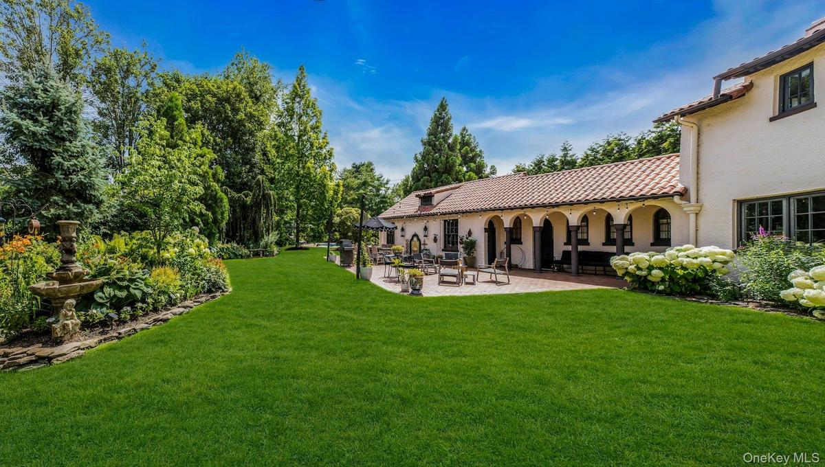 Private country club backyard featuring mature landscaping, fully fenced, brick patios, IGP & Spa, fountains