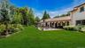 Private country club backyard featuring mature landscaping, fully fenced, brick patios, IGP & Spa, fountains
