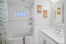 Full bath featuring shower / tub combo with curtain and vanity