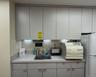 Kitchen featuring light countertops, gray cabinets, freestanding refrigerator, and modern cabinets