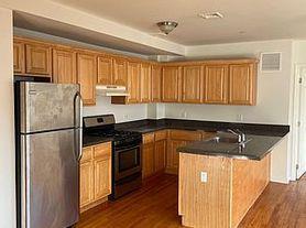 Kitchen with kitchen peninsula, sink, dark hardwood / wood-style floors, and appliances with stainless steel finishes
