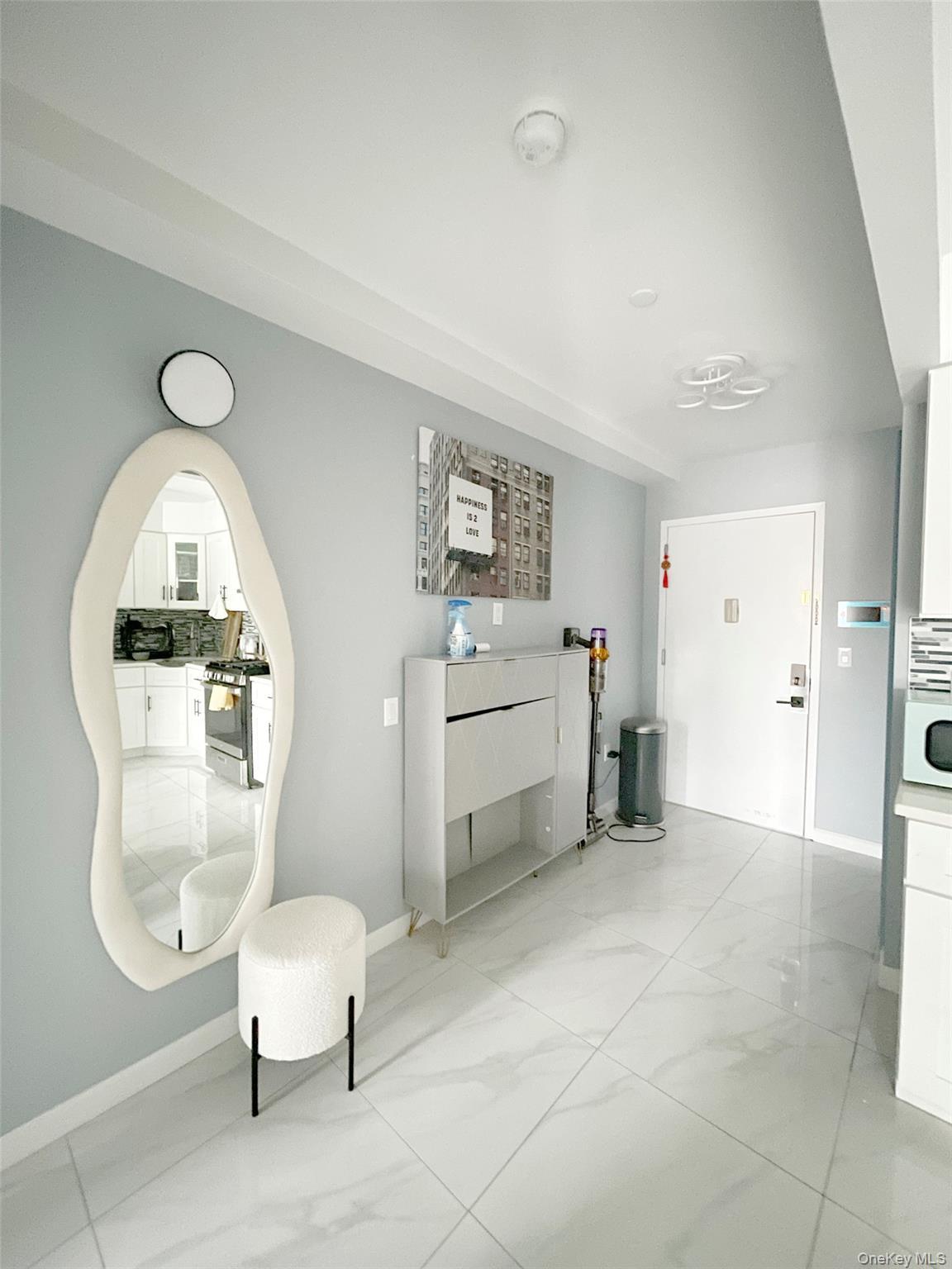 Sitting room with baseboards and light marble finish floors