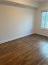 2nd Bedroom, featuring enough space for a full or queen size bed and hardwood flooring.