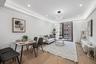 Living room featuring wood finished floors, recessed lighting, and a tray ceiling