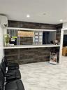 Entrance to the Physical Therapist Retail Tenant featuring a wall mounted mini split, recessed lighting, and wood walls