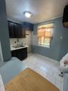 Kitchen with light countertops, tasteful backsplash, and light tile patterned floors
