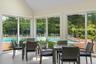 Sunroom / solarium with vaulted ceiling and view of scattered trees