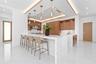 The gourmet kitchen is a chef’s dream, featuring marble countertops, real wood cabinetry,