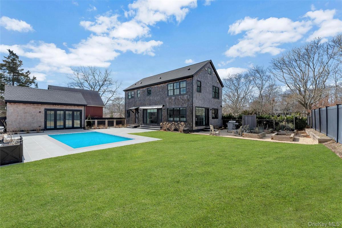 Private outdoor oasis with an in-ground heated pool, bluestone patio, and detached pool house in the heart of New Suffolk.