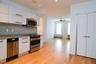 Kitchen with appliances with stainless steel finishes, backsplash, ceiling fan, light wood finished floors, and recessed lighting