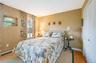 Bedroom with baseboards, wood finished floors, and baseboard heating