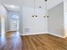 bright open-concept layout with new vinyl flooring, a fully renovated kitchen