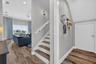Entry downstairs into second living area with one guest room to your right and two to your left.