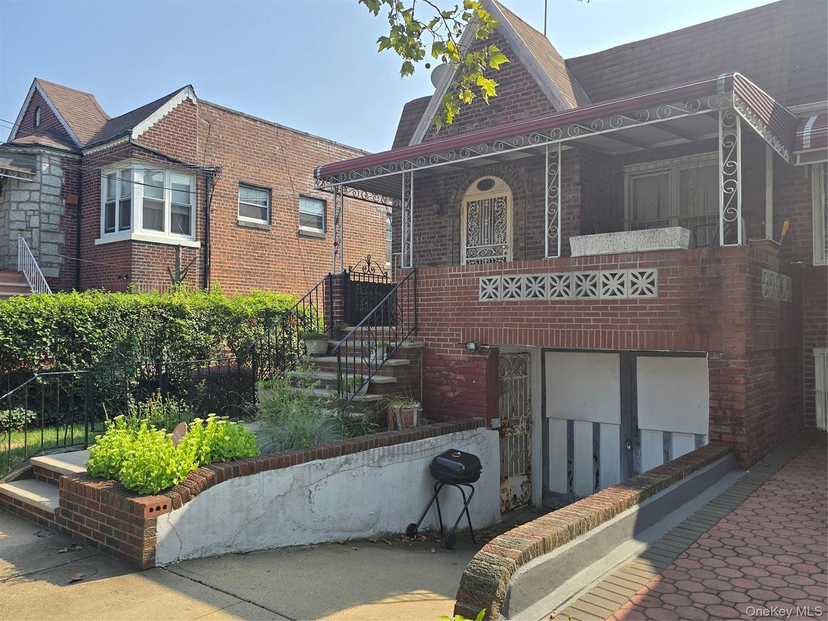 View of front of home with brick siding and a porch