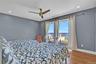 Bedroom 3 featuring a water view, wood finished floors, access to exterior, a ceiling fan, and recessed lighting
