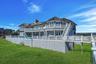 Back of property with expansive deck and pool