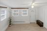 Entryway with light wood finished floors, a baseboard radiator, and a ceiling fan