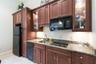 Wall Kitchenette in the 600 square foot wing on one side of this home that would be a perfect as an  in law suite or guest suite. The travertine is co