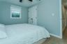 Bedroom featuring ceiling fan, light wood-type flooring, and a closet