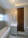 Full bath with baseboard heating, shower / washtub combination, vanity, and tile patterned flooring