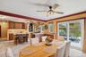 Dining area with light tile patterned flooring, ceiling fan, and crown molding